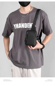 Close-up of tactical black mini chest bag with durable nylon fabric and wide shoulder strap