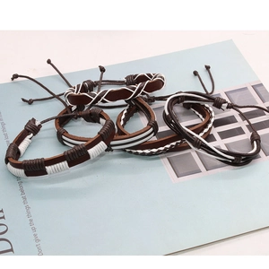 Detail of 5-piece retro braided leather and wax cord bracelets for men displayed on a magazine