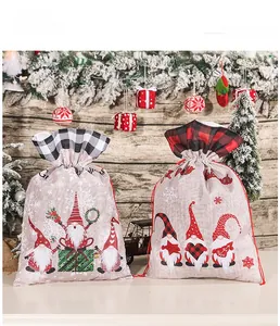 Detail of Christmas burlap gnome gift bags with festive plaid drawstrings and wood backdrop
