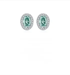 Detailed close-up of S925 silver stud earrings with oval green gemstone and halo diamonds