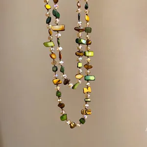 Irregular shell and crystal beaded necklace with yellow, green, and brown stones