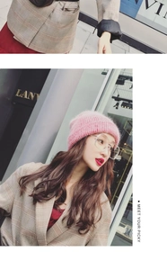 Close-up of a pink knit beanie paired with stylish transparent glasses on a model