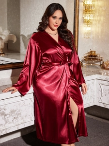 Detailed macro view of the glossy wine red satin robe with an elegant side split hem