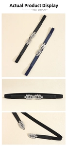 Detail of leaf-shaped silver metal buckle on elastic waist belts in black and navy blue