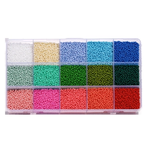 Top view of 15-grid storage box filled with colorful matte glass beads for DIY jewelry making