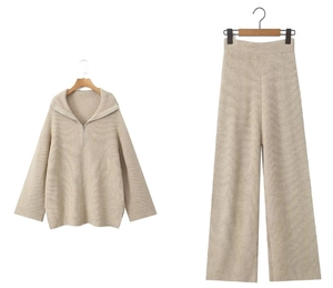 Detail of apricot ribbed knit two-piece set featuring half-zip collar and wide-leg trousers