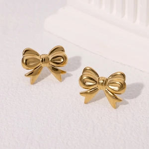 Elegant 18k gold plated stainless steel bow stud earrings on a white minimalist background