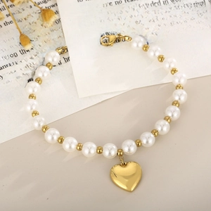 French vintage pearl bracelet with gold heart pendant and metallic beads on white background