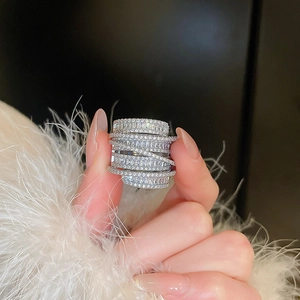 Detailed view of silver multi-layer wide ring with pavé-set shimmering zircon stones