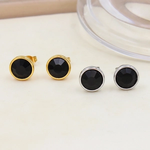 Detail of round black gemstone earrings in gold and silver stainless steel frames