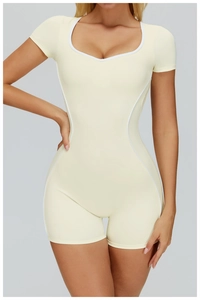 Close-up of cream yoga bodysuit with white contrast piping and body-shaping fit