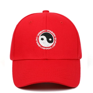 Detailed embroidery of Tai Chi symbol and Swimming text on a red cotton baseball cap