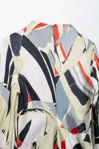 Close-up of abstract geometric print satin dress back featuring invisible zipper