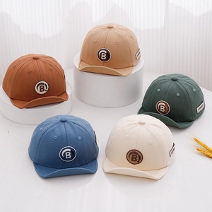 Toddler baseball caps with letter B patch in five neutral colors on display