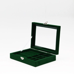 Dark green velvet jewelry box with transparent glass lid and silver metal lock closure