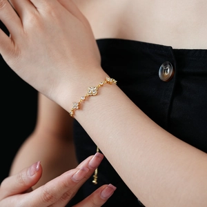 Detail of a gold-plated flower bracelet with micro-pave zircons and adjustable slider clasp