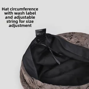Detail of coffee bucket hat showing adjustable inner drawstring and size label