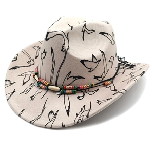 Off-white wool cowboy hat with black bird prints and ethnic beaded hatband detailing