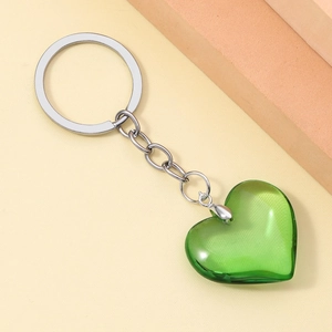 Close-up of a translucent green 3D resin heart keychain with a silver metal ring and chain