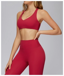 Close-up of deep red sports bra with racerback design and matching high-waisted leggings