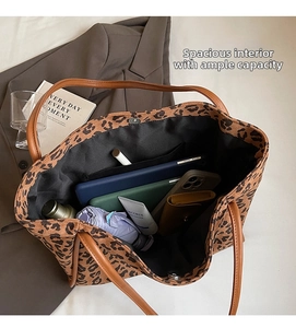 Detailed interior of a large leopard print tote bag showing storage for daily essentials