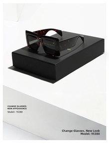 Detail view of tortoiseshell square sunglasses model 95380 on a minimalist black gift box