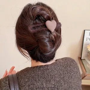 Elegant warm coffee brown heart-shaped plush hair claw clip for chic bun hairstyles