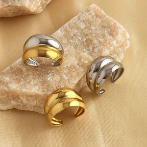 Polished stainless steel geometric layered ear cuffs in gold and silver on stone