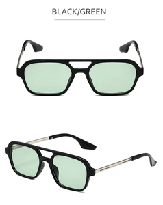 Detail view of black square aviator sunglasses with green lenses and silver metal temples