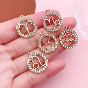 Gold zodiac pendants with white rhinestones featuring various constellation signs