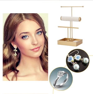 Three-tier gold jewelry stand featuring storage tray and detail views of earring holders