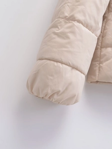 Close-up of elastic sleeve cuff stitching on beige winter cotton padded jacket