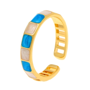 Golden open bangle with blue and cream enamel square patterns in minimalist geometric design
