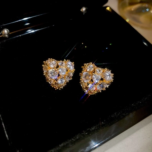Macro shot of 18k gold plated heart earrings with sparkling cubic zirconia pavé setting