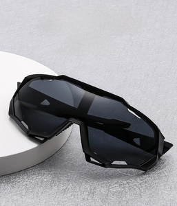 Detail of black oversized cycling sunglasses with a trendy one-piece lens design
