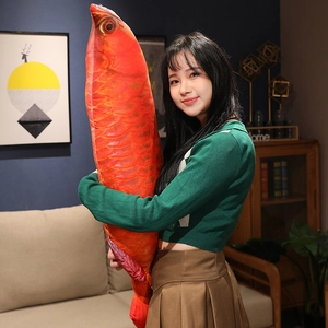 Detail of a large 100cm lifelike orange-red fish plush pillow with realistic scale texture