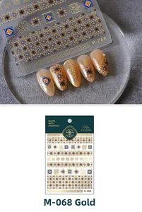 Macro detail of M-068 gold nail stickers with geometric patterns and floral textures