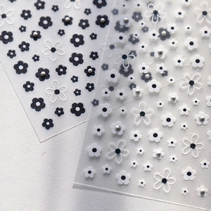 3D floral nail art stickers with black and white daisy patterns and silver pearl accents