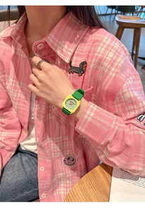 Detail shot of a stylish green silicone strap and yellow square case student watch