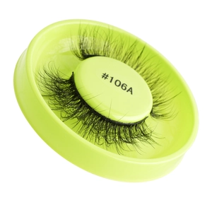 Detail view of self-adhesive black false eyelashes model #106A in a light green round case