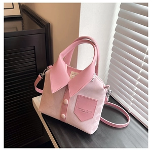 Detail of pink shirt-shaped leather tote bag with collar and button design