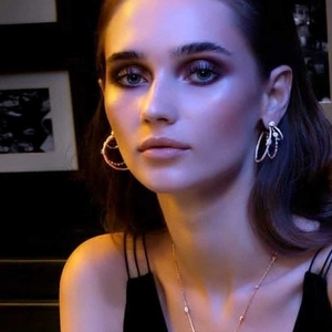 Three-layer hollow oval cubic zirconia earrings and necklace set on an elegant model
