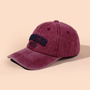 Detail of embroidered Brooklyn 1947 lettering on a washed red baseball cap