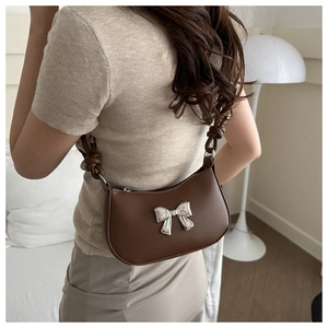 Brown PU leather shoulder bag featuring a stylish silver metal bow and knotted strap detail