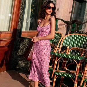Detail view of pink floral summer slip dress with a Bohemian vibe on a street model