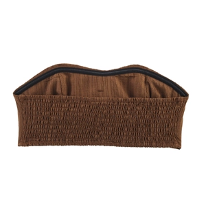 Detailed close-up of brown smocked fabric texture on a two-piece vacation crop top