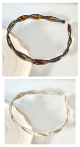 Detail of cellulose acetate twisted headbands with non-slip teeth in tortoiseshell and cream