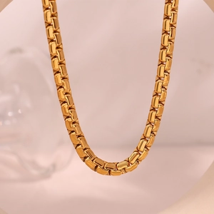Macro detail of 6.2mm golden geometric square box chain necklace in polished finish