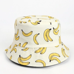 Detail of banana print on cream canvas reversible bucket hat with neat stitching