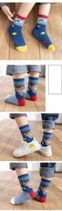 Detail of knit cotton kids socks featuring astronaut bear patterns and ribbed cuffs